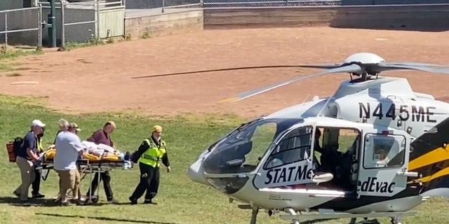 In this still image from video, author Salman Rushdie is taken on a stretcher to a helicopter for transport to a hospital after he was attacked during a lecture at the Chautauqua Institution in Chautauqua, N.Y., Friday, Aug. 12, 2022. 