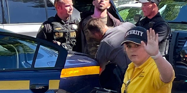 Add names of persons detained Law enforcement officers detain Hadi Matar, 24, of Fairview, N.J., Friday, Aug. 12, 2022, outside the Chautauqua Institute in Chautauqua, N.Y.  Salman Rushdie, the author who led to death threats from Iran in the 1980s, was attacked and apparently stabbed in the neck Friday by Matar, who rushed to the stage to give a lecture at a research institute in western New York. 