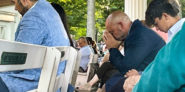 People gather at an evening vigil pray and observe a moment of silence after an attack on author Salman Rushdie, Friday Aug. 12, 2022, in Chautauqua, N.Y. Rushdie, whose novel "The Satanic Verses" drew death threats from Iran in the 1980s, was stabbed as he was about to give a lecture.