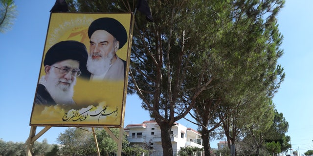 Portraits of the late revolutionary founder Ayatollah Khomeini and the Supreme Leader Ayatollah Ali Khamenei, are displayed at the entrance of the Lebanese-Israeli border village of Yaroun, south Lebanon, Saturday, Aug. 13, 2022, where the parents of Hadi Matar emigrated from. On Friday, Matar, 24, born in Fairview, N.J., attacked author Salman Rushdie during a lecture in New York. His birth was a decade after "The Satanic Verses" was first published. 