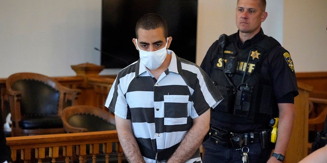 Hadi Matar, 24, center, arrives for an arraignment in the Chautauqua County Courthouse in Mayville, N.Y., Saturday, Aug. 13, 2022. Matar, who is accused of carrying out a stabbing attack against "Satanic Verses" author Salman Rushdie has entered a not-guilty plea in a New York court on charges of attempted murder and assault. An attorney for Matar entered the plea on his behalf during an arraignment hearing.  