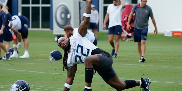 Tennessee Titans running back Derrick Henry stretches during NFL football training camp July 27, 2022, in Nashville, Tennessee. The NFL essentially is back to normal going into its third season dealing with COVID-19.