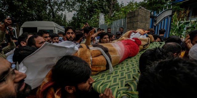 Kashmiri villagers carry the body of Sunil Kumar, a Kashmiri Hindu man, outside his home at Chotigam village, near the south of Srinagar, Indian-controlled Kashmir. He was shot dead by suspected rebels at an apple orchard on Tuesday morning, while his brother was injured in the attack, officials said.