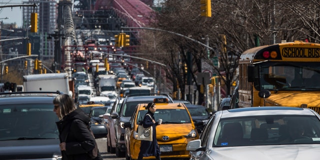 Pedestrians cross Delancey Street as congested traffic from Brooklyn enters Manhattan over the Williamsburg Bridge in New York. Roadway deaths rose 7% during the first three months of 2022 to 9,560 people, the highest number for the first quarter in two decades.