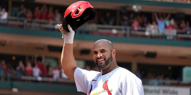 St. Louis Cardinals' Albert Pujols tips his cap after hitting a grand slam during the third inning of a baseball game against the Colorado Rockies Thursday, Aug. 18, 2022, in St. Louis. 