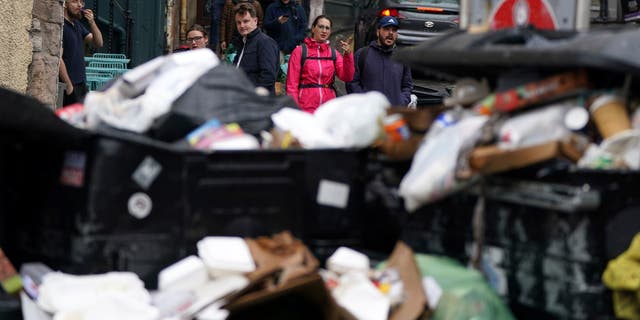 A view of overflowing bins in the Grassmarket area of Edinburgh where cleansing workers from the City of Edinburgh Council are on the fourth day of eleven of strike action, in Scotland, Wednesday, Aug. 24, 2022.