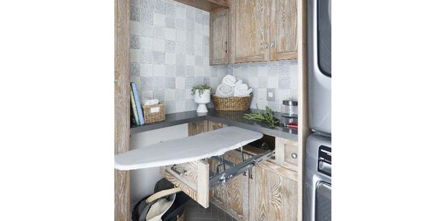 Jeanne Chung of CozyStylishChic, an interior design company in California, likes to make the laundry room multifunctional. Here she has an ironing board, storage baskets and shelves.