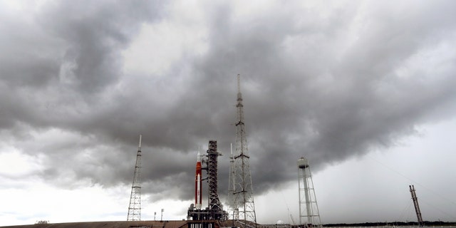 Storm clouds roll in over the NASA moon rocket as it stands ready for launch on Pad 39B for the Artemis 1 mission at the Kennedy Space Center, Saturday, Aug. 27, 2022, in Cape Canaveral, Fla. The launch is scheduled for Monday morning Aug. 29.