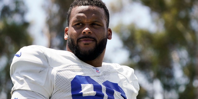 Los Angeles Rams defensive tackle Aaron Donald stands on the field at the NFL football team's practice facility Monday, Aug. 28. 1, 2022, in Irvine, CA.