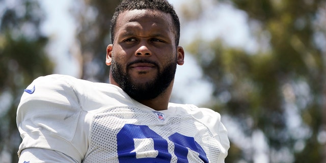 Los Angeles Rams defensive tackle Aaron Donald stands on the field at the NFL football team's practice facility in Irvine, Calif., Monday, Aug. 1, 2022.