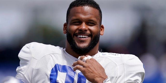 Los Angeles Rams defensive end Aaron Donald smiles during NFL football practice Saturday July 30, 2022 in Irvine, Calif. 