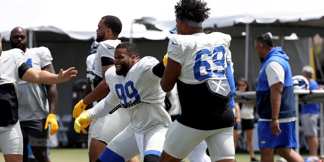 Los Angeles Rams defensive lineman Aaron Donald (99) does drills with defensive lineman Elijah Garcia (69) during training camp at University of California Irvine, July 30, 2022, in Irvine, California.