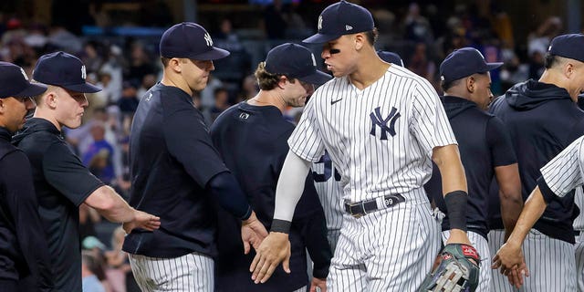 New York Yankees' Aaron Judge celebrates a win with teammate after a baseball game against the New York Mets, Monday, Aug. 22, 2022, in New York. 