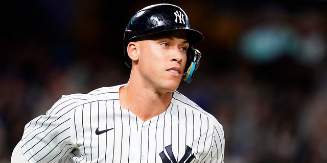 New York Yankees' Aaron Judge smiles as he runs the bases after hitting a home run during the fourth inning of a baseball game against the New York Mets Tuesday, Aug. 23, 2022, in New York.