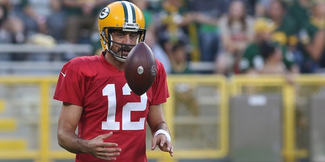Green Bay Packers quarterback Aaron Rodgers flips a ball during Green Bay Packers Family Night at Lambeau Field, Aug. 5, 2022, in Green Bay, Wis.