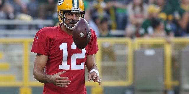 Green Bay Packers quarterback Aaron Rodgers flips a ball during Green Bay Packers Family Night at Lambeau Field, Aug. 5, 2022, in Green Bay, Wis.