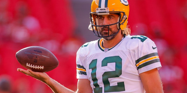 Aaron Rodgers #12 of the Green Bay Packers participates in a pregame warmup before their preseason game against the Kansas City Chiefs at Arrowhead Stadium in Kansas City, Missouri on August 25, 2022.