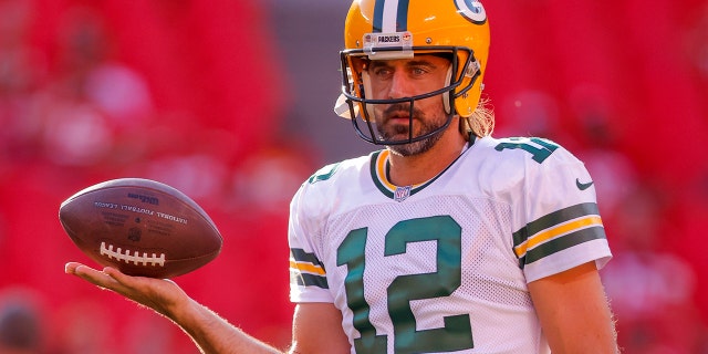 Aaron Rodgers #12 of the Green Bay Packers participates in a pregame warmup before their preseason game against the Kansas City Chiefs at Arrowhead Stadium in Kansas City, Missouri on August 25, 2022.