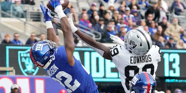 Las Vegas Raiders wide receiver Brian Edwards (right) makes a pass in the end zone as New York Giants cornerback Adley Jackson plays defense on November 7, 2021 at MetLife Stadium in East Rutherford, N.J. can't catch