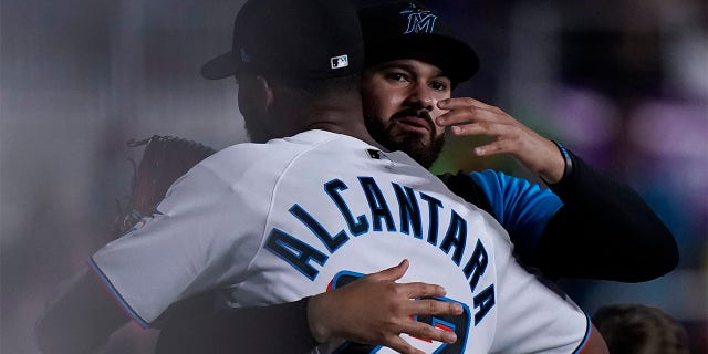 Miami Marlins starting pitcher Sandy Alcantara (22) is congratulated by Pablo Lopez after the Marlins beat the Cincinnati Reds 3-0 in a baseball game, Wednesday, Aug. 3, 2022, in Miami.