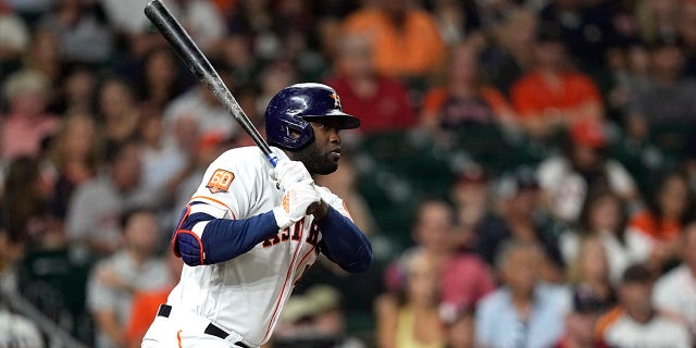 Houston Astros' Jordan Alvarez looks to hit a single against the Minnesota Twins in the third inning of a baseball game, Tuesday, Aug. 23, 2022, in Houston.