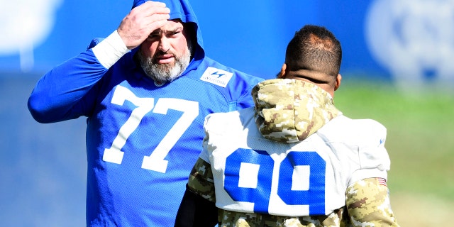 Offensive tackle Andrew Whitworth (77) of the Los Angeles Rams talks with defensive tackle Aaron Donald (99) during practice in preparation for Super Bowl LVI at the Rams training facility on Feb. 9, 2022, in Thousand Oaks, California.