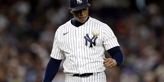 New York Yankees pitcher Aroldis Chapman reacts as he waits to be tagged out during the ninth inning of a baseball game against the Toronto Blue Jays, Friday, Aug. 19, 2022, in New York.