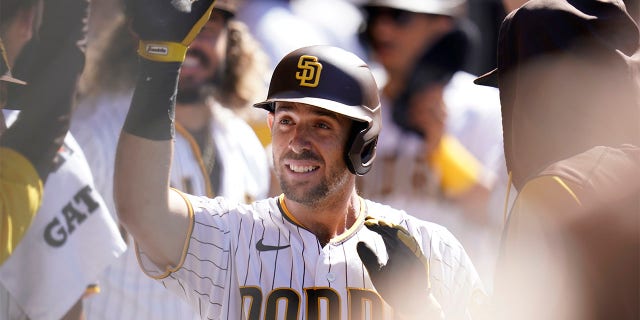 Austin Nola of the San Diego Padres celebrates with teammates after scoring a two-run double by Manny Machado in the third inning of a baseball game against the San Francisco Giants in San Diego, Wednesday, Aug. 10, 2022. . 