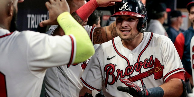 Austin Riley of the Atlanta Braves, right, celebrates with teammates after hitting a double home run against the Los Angeles Angels during the fourth inning, July 23, 2022, in Atlanta.