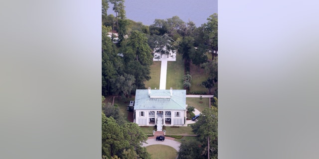 An immaculate white walkway extends from the steps of the mansion to the riverside on Ben Affleck's 87-acre property.