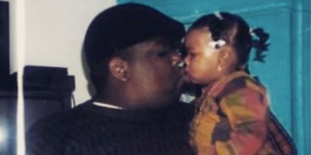 Notorious B.I.G. holding his only daughter, T'yanna Wallace, now 29. Her boyfriend and the father of her infant, Tyshawn Baldwin, was arrested for a hit-and-run Aug. 16, 2022.