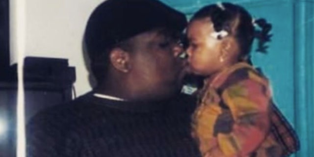 Notorious B.I.G. holding his only daughter, T'yanna Wallace, now 29. Her boyfriend and the father of her infant, Tyshawn Baldwin, was arrested for a hit-and-run Aug. 16, 2022.