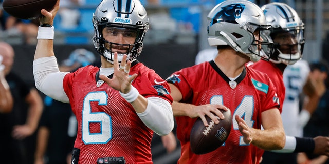 Carolina Panthers quarterbacks Baker Mayfield, #6, and Sam Darnold throw during drills at the NFL football team's Fan Fest in Charlotte, North Carolina, Thursday, Aug. 11, 2022.