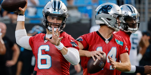 Carolina Panthers quarterbacks Baker Mayfield, #6, and Sam Darnold throw during drills at the NFL football team's Fan Fest in Charlotte, North Carolina, Thursday, Aug. 11, 2022.