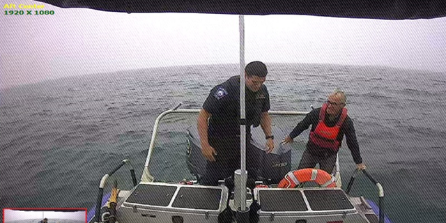 The sailor is pictured after officers pulled him onto their patrol boat in the waters off Martha's Vineyard near Cape Cod, Mass.