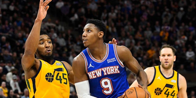 Donovan Mitchell, #45 of the Utah Jazz, defends RJ Barrett, #9 of the New York Knicks, during the second half of a game at Vivint Smart Home Arena on February 07, 2022 in Salt Lake City.