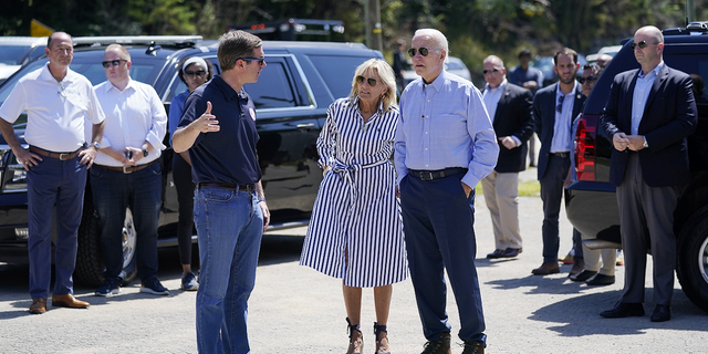 President Joe Biden and first lady Jill Biden talk with Gov. Andy Beshear while they view flood damage in Lost Creek, Kentucky, on Aug. 8.