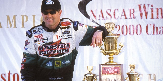 Bobby Labonte poses with the Winston Cup trophy after winning the title for Joe Gibbs Racing. won the
