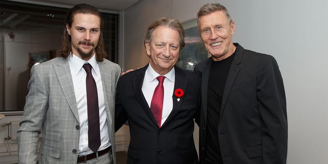 Ottawa Senators owner Eugene Melnyk, center, poses for a photo with Erik Karlsson, left, and Borje Salming at the Canadian Embassy in Stockholm, Sweden on November 7, 2017.