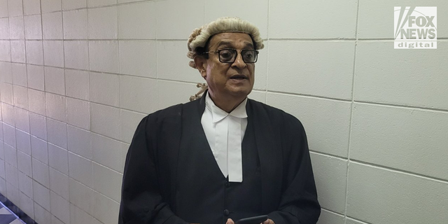 Bradley Dawson's lawyer, Iqbal Khan, speaks with reports outside the courtroom in Fiji.