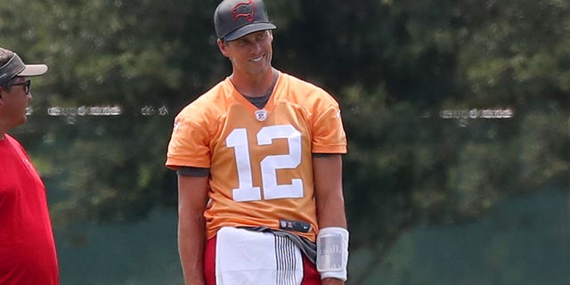 Tampa Bay Buccaneers quarterback Tom Brady smiles during training camp Aug. 22, 2022, at the AdventHealth Training Center at One Buccaneer Place in Tampa, Fla.