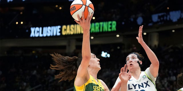 Storm forward Breanna Stewart shoots against Minnesota Lynx forward Jessica Shepard, Aug. 3, 2022, in Seattle.