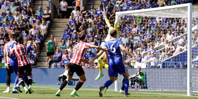 Brentford goalkeeper David Raya fails to stop Leicester City's Timothy Castagne's header from a corner during the English Premier League soccer match between Leicester City and Brentford at the King Power Stadium in Leicester, England, on Sunday. August, 7, 2022.