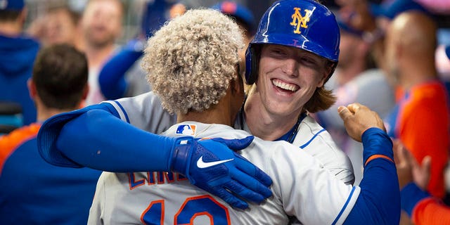The New York Mets' Francisco Lindor, back to camera, celebrates with Brett Baty, who hit a two-run home run against the Atlanta Braves during the second inning Wednesday, Aug. 17, 2022, in Atlanta.