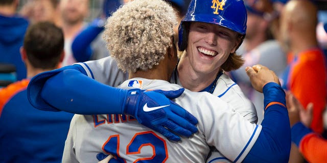 The New York Mets' Francisco Lindor, back to camera, celebrates with Brett Baty, who hit a two-run home run against the Atlanta Braves during the second inning Wednesday, Aug. 17, 2022, in Atlanta.