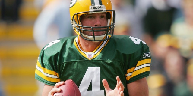 Quarterback Brett Favre, #4 of the Green Bay Packers, attempts a pass against the New York Giants on October 3, 2004 at Lambeau Field in Green Bay, Wisconsin.
