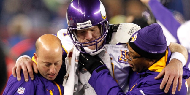 Brett Favre was helped off the field after suffering a injury late in the fourth quarter.