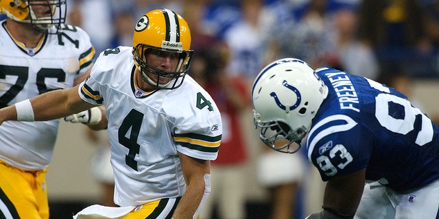 Brett Favre, #4 of the Green Bay Packers, injured his leg on this play after throwing the ball as Dwight Freeney, #93 of the Indianapolis Colts, pursed him during a game at the RCA Dome on September 26, 2004 in Indianapolis.