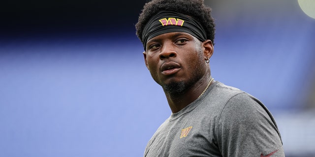 Brian Robinson of the Washington Commanders warms up before the preseason game against the Baltimore Ravens in Baltimore, Maryland, on Aug. 27, 2022.