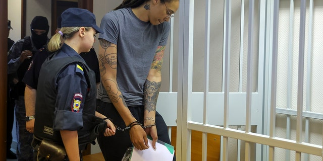 WNBA star and two-time Olympic gold medalist Brittney Griner enters a cage in a courtroom prior to a hearing in Khimki, Russia, just outside of Moscow, on Aug. 4, 2022.